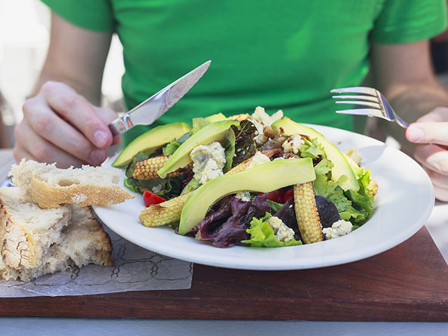 person eating plate of healthy salad